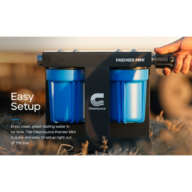 Clearsource Premier Mini RV water filter lifestyle photo showing a person hooking the hose up into the water filter system outside in the sunset easy setup 