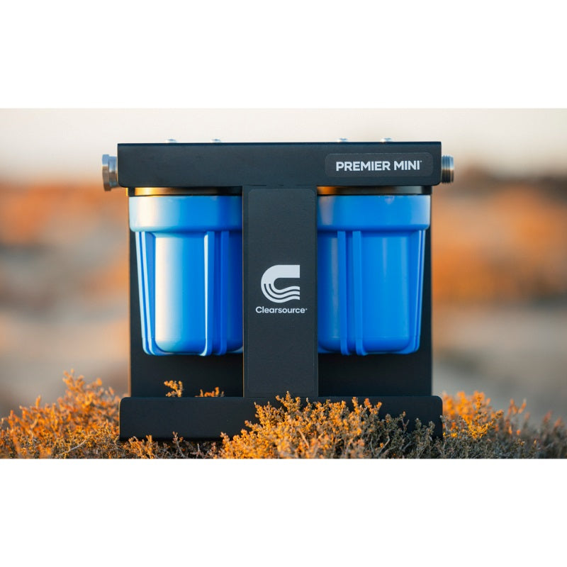 Clearsource Premier Mini water filter lifestyle photo showing the water filter system sitting in the grass in the sunset