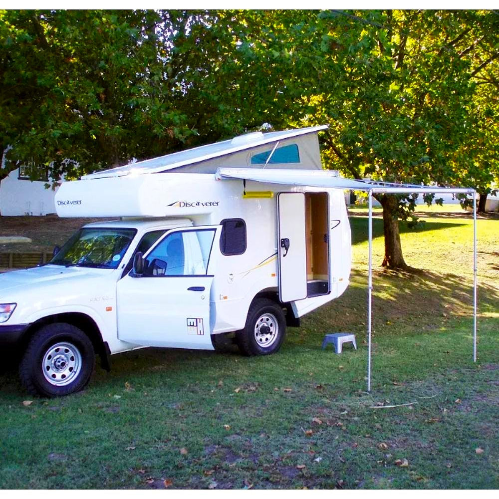 fiamma f35 pro 220 image that shows a fully extended polar white RV awning attached to a white camper corner view