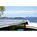 fiamma f35 pro 250 lifestyle closeup image that shows the titanium color awning fully extended on a vehicle in front of the lake