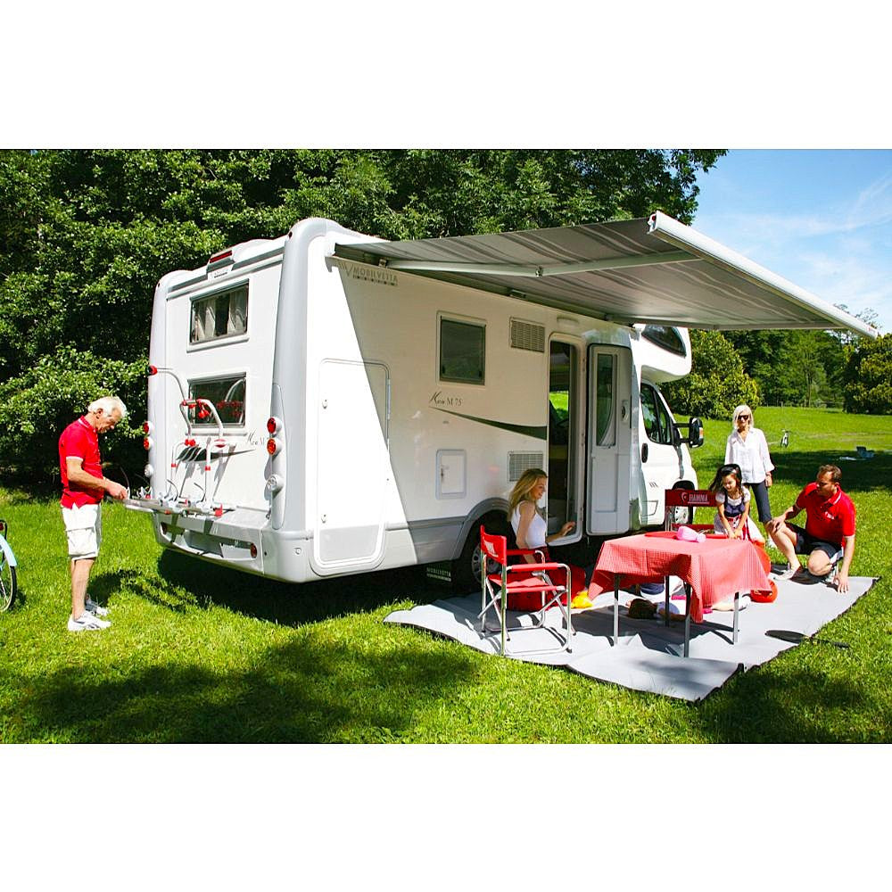 fiamma f45 awning jayco eagle lifestyle image showing several people sitting under the fully extended RV awning with table and chairs