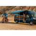 fiamma f80s review lifestyle image showing a black RV and man with bike in desert